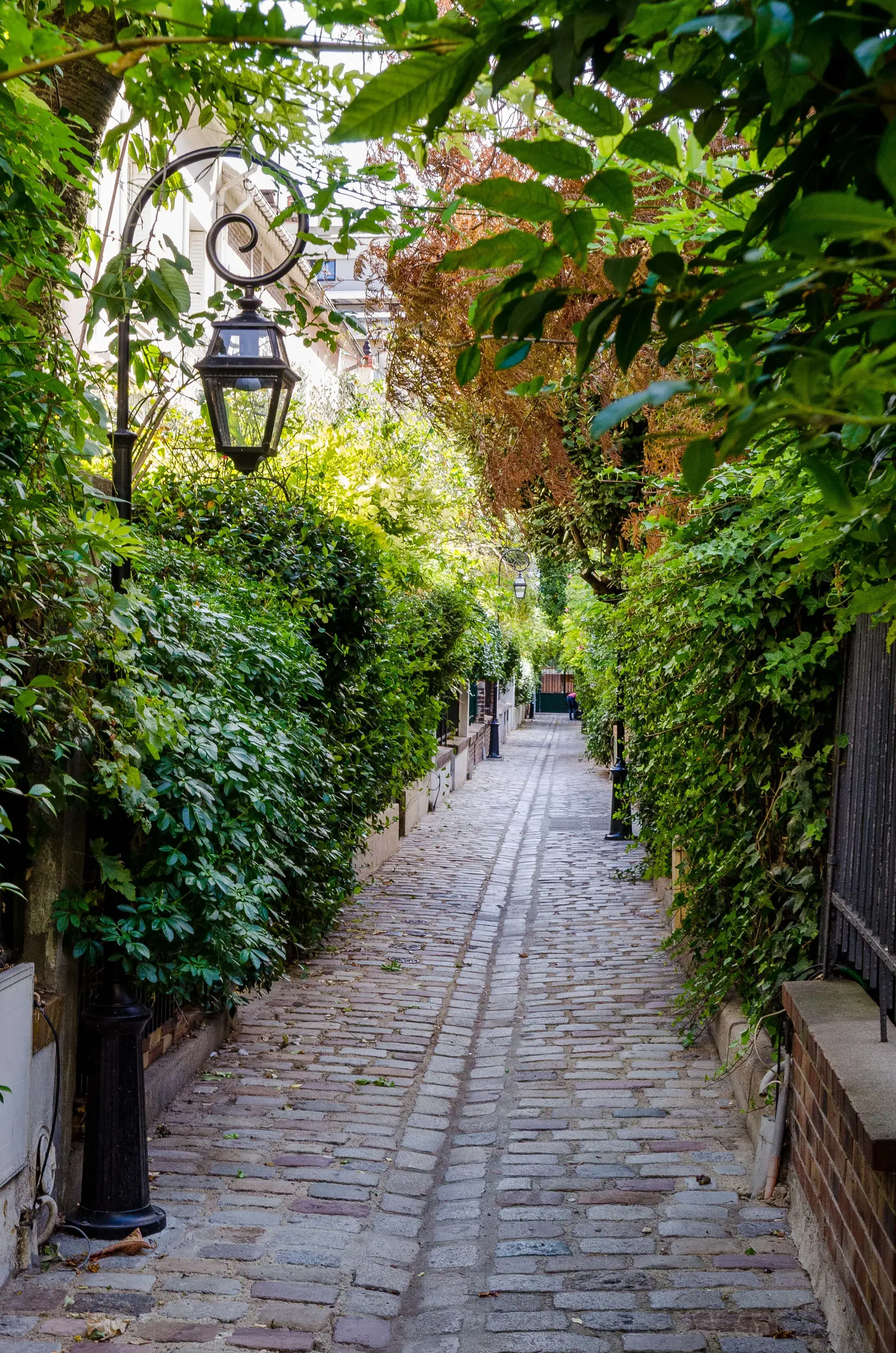 Ruelle pavée et villa verdoyante bordée de lanternes anciennes, quartier Auteuil, Paris 16e